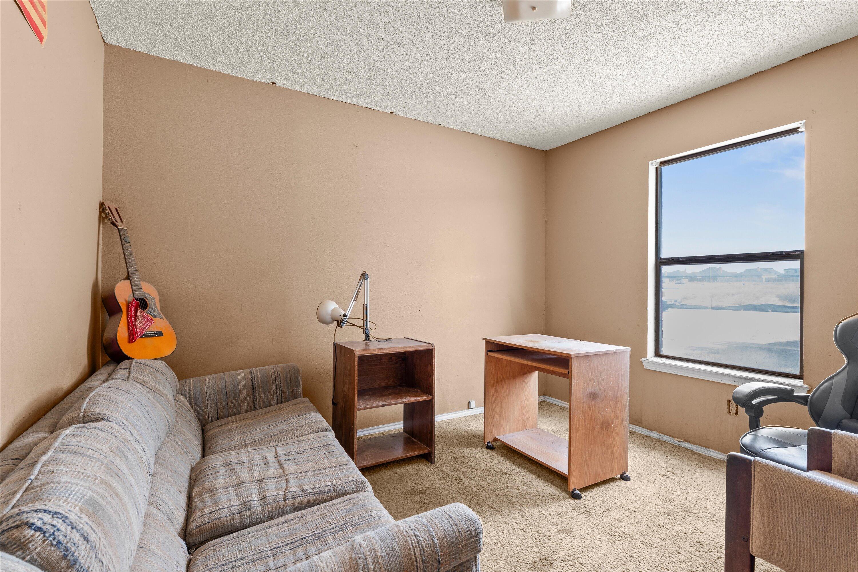 1605 Corpus Avenue Wolfforth, TX 79382 - Photo 12 of 20 a bedroom with furniture and a fireplace