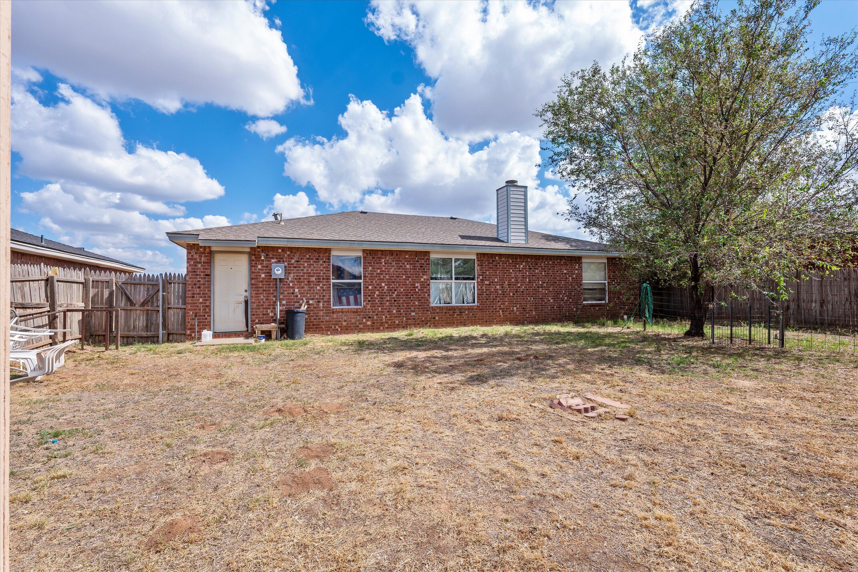 1605 Corpus Avenue Wolfforth, TX 79382 - Photo 19 of 20 a view of a house with a yard and garage