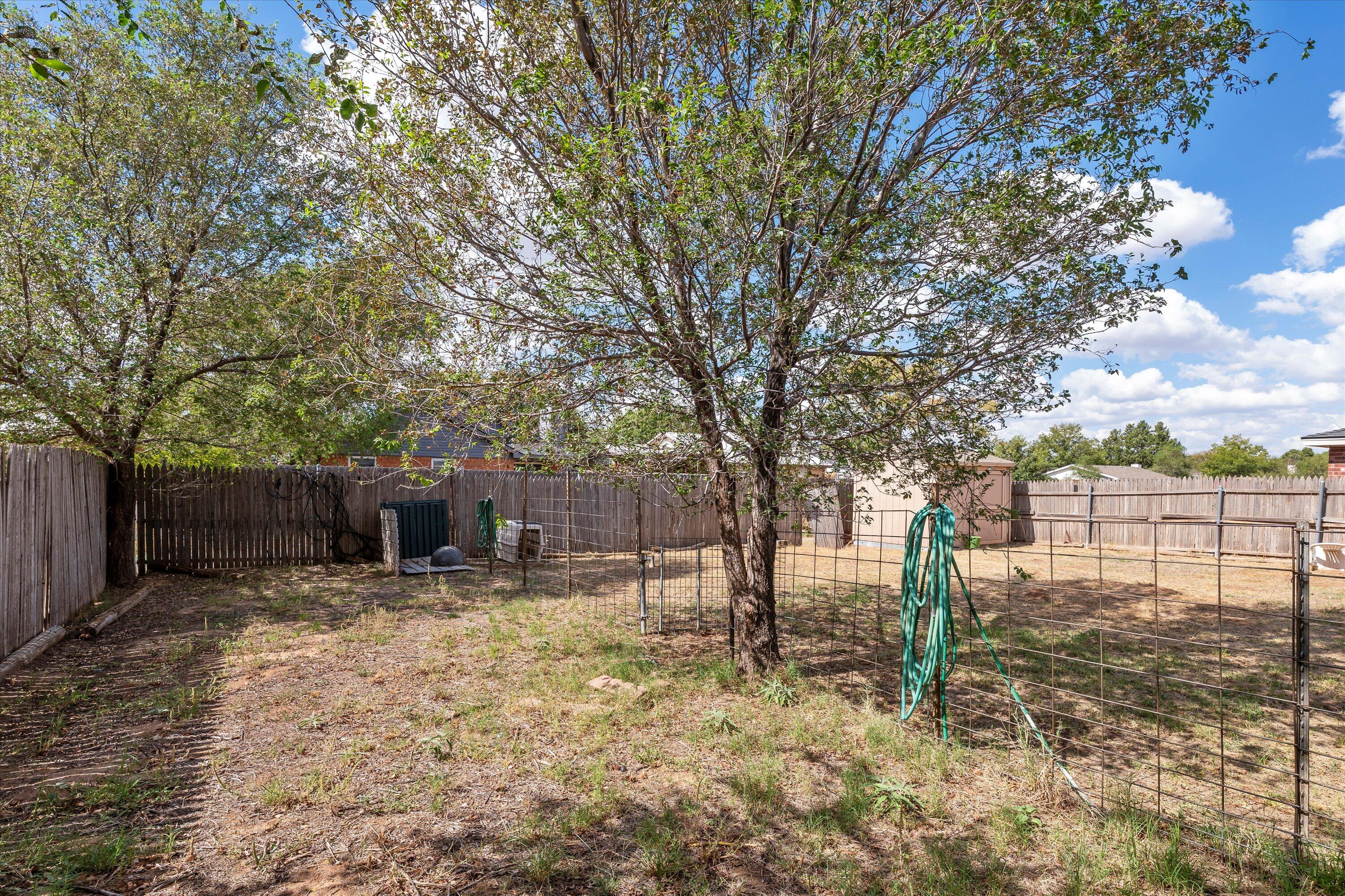 1605 Corpus Avenue Wolfforth, TX 79382 - Photo 20 of 20 a backyard of a house with cars parked trees