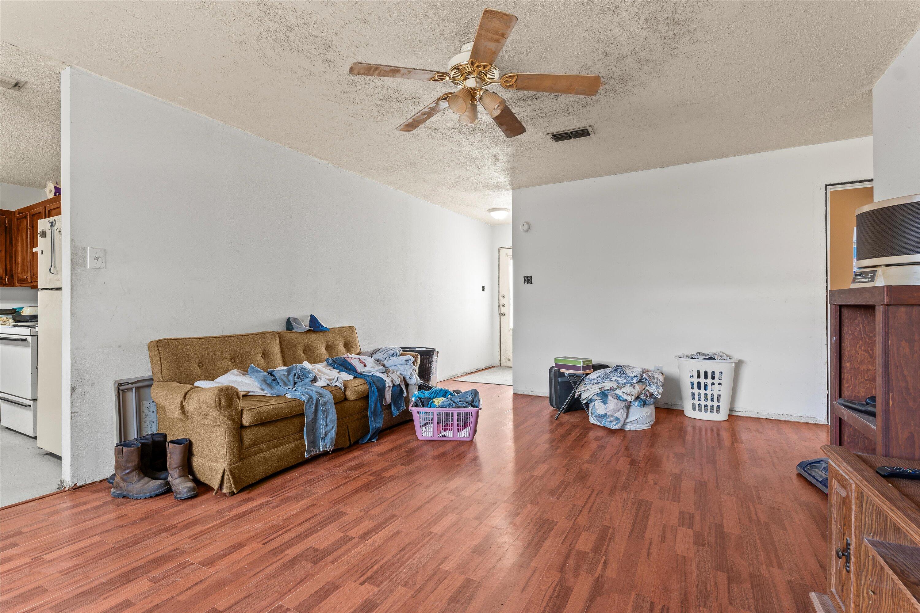 1605 Corpus Avenue Wolfforth, TX 79382 - Photo 5 of 20 a living room with furniture a flat screen tv and a ceiling fan