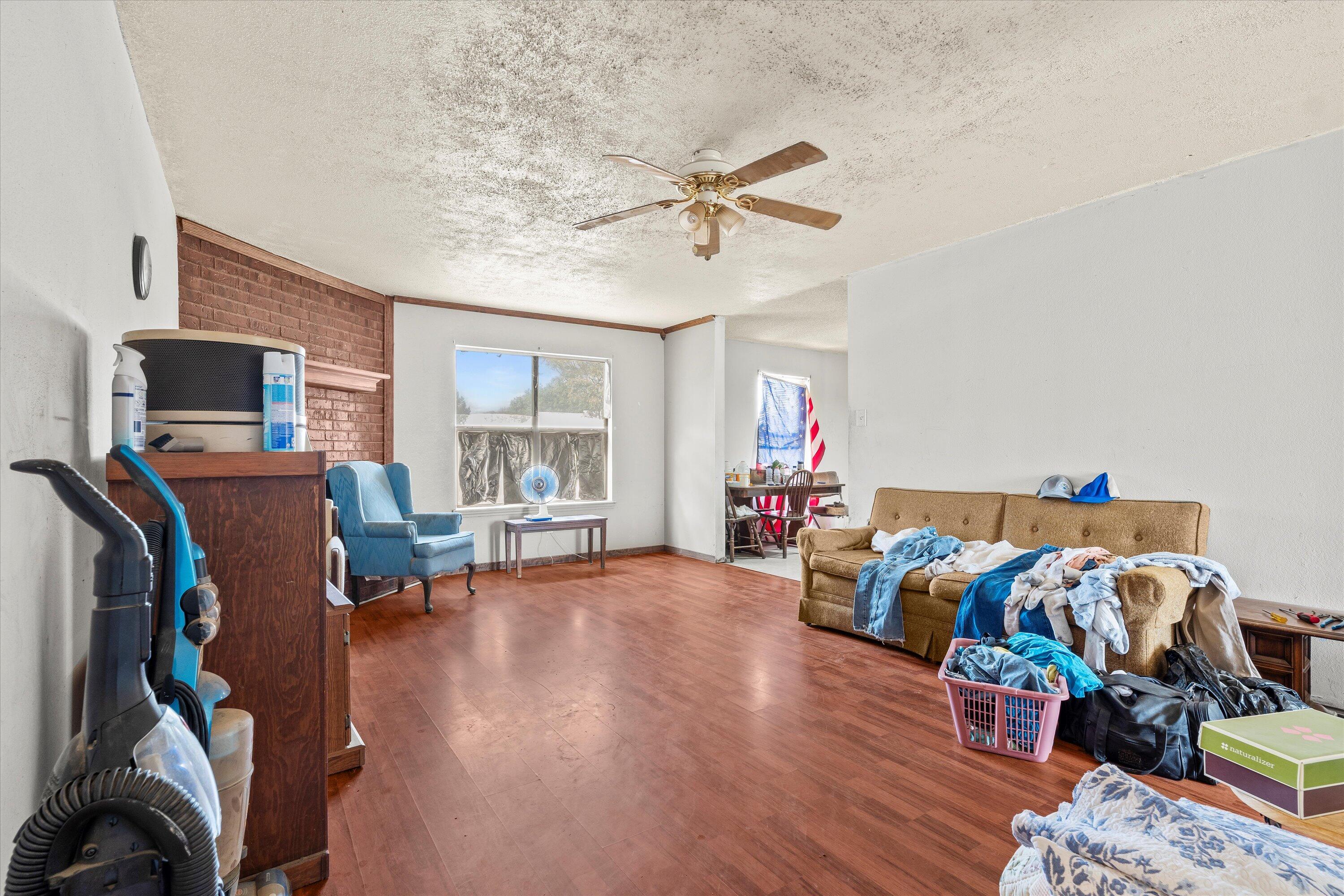1605 Corpus Avenue Wolfforth, TX 79382 - Photo 6 of 20 a bed room with furniture and a flat screen tv