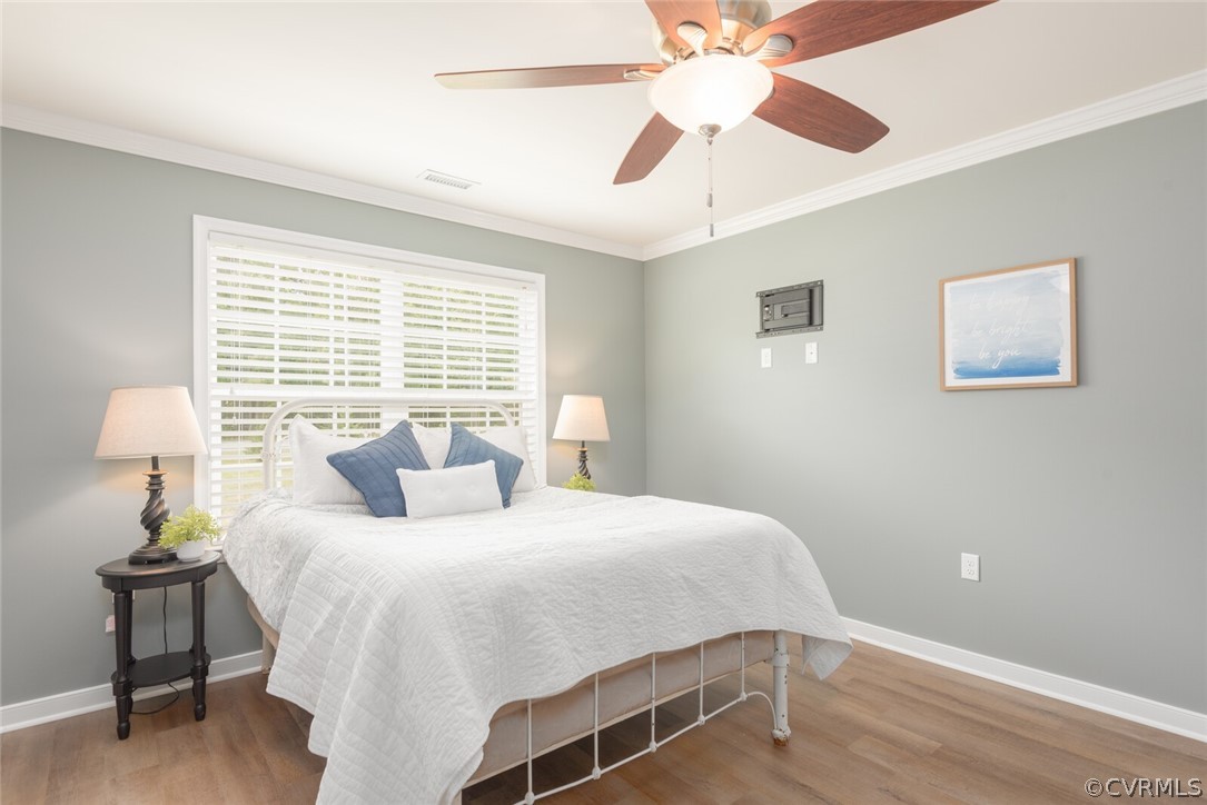 2070 Genito Road Moseley, VA 23120 - Photo 11 of 44 a bedroom with a bed and a chandelier