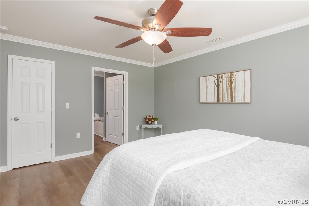 2070 Genito Road Moseley, VA 23120 - Photo 12 of 44 a bedroom with a large bed and a chandelier