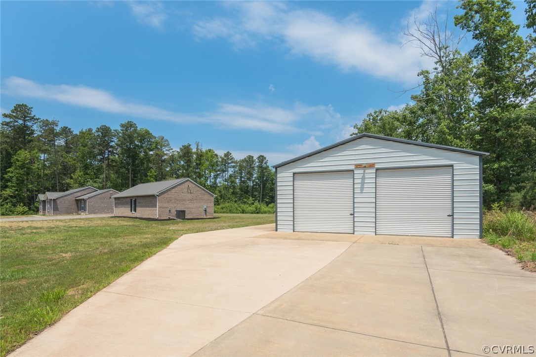 2070 Genito Road Moseley, VA 23120 - Photo 33 of 44 a front view of a house with a yard and garage