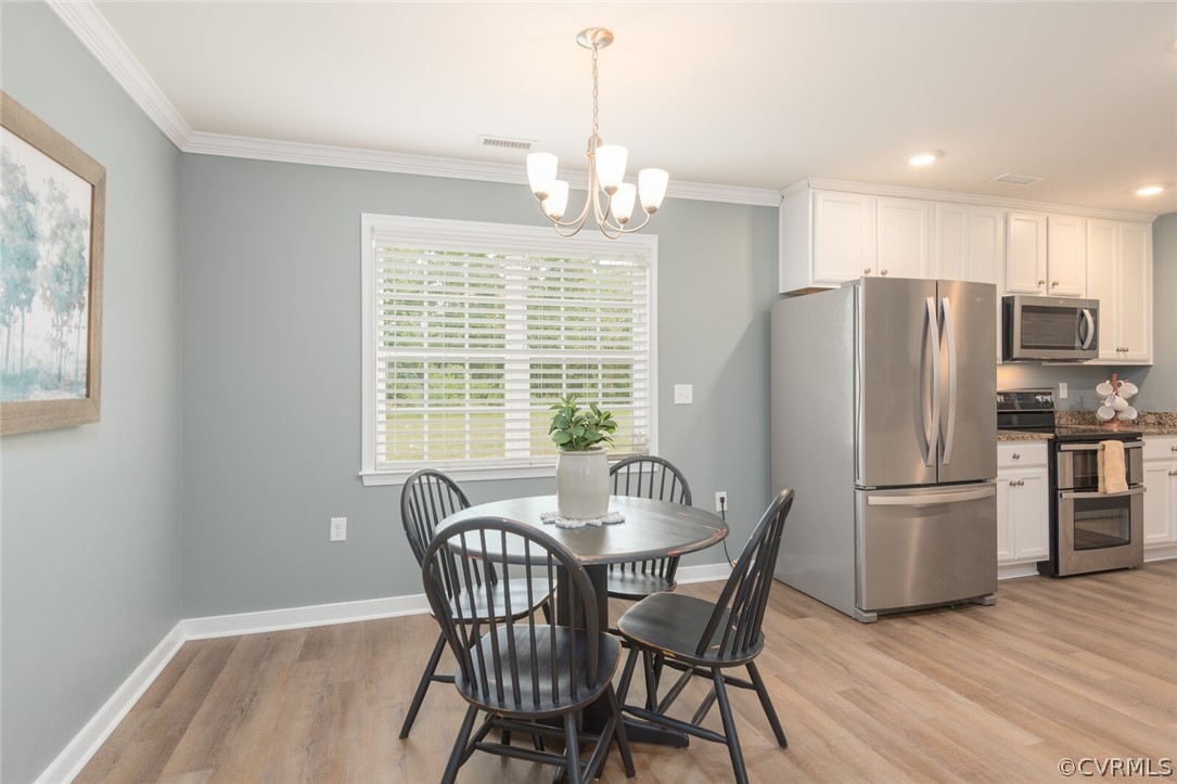 2070 Genito Road Moseley, VA 23120 - Photo 7 of 44 a dining room with furniture a chandelier and wooden floor