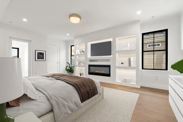 a spacious bedroom with a large bed and a fireplace