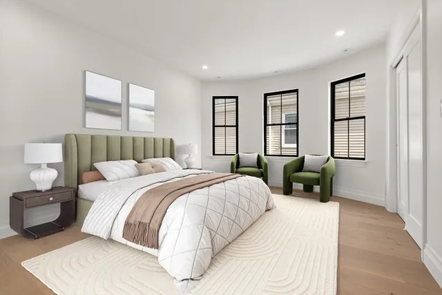 a bedroom with a bed couch and window