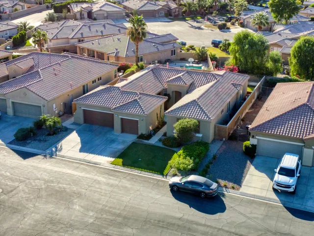 an aerial view of a house with garden space and street view