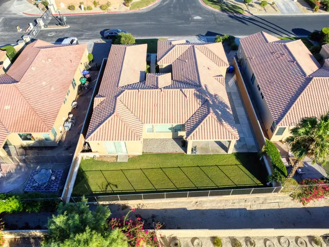 a view of a tennis ground with large trees