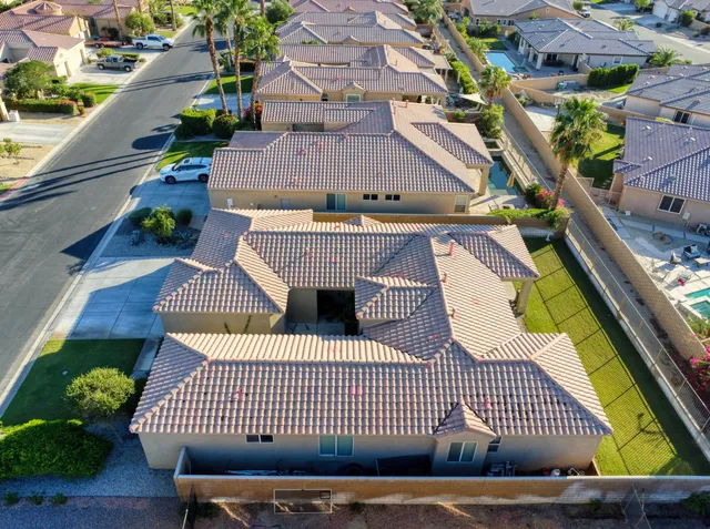 an aerial view of a house with garden space and a street view