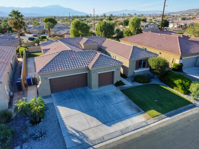 an aerial view of multiple houses with a yard