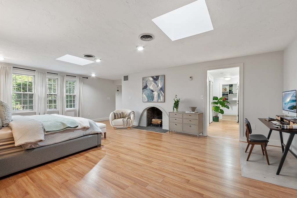 2 Partridge Hill Road Dover, MA 02030 - Photo 18 of 31 a spacious bedroom with a bed and a fireplace