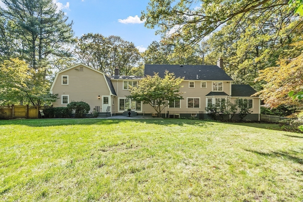 2 Partridge Hill Road Dover, MA 02030 - Photo 2 of 31 a front view of a house with a yard and garage