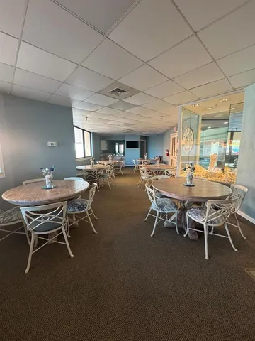 a view of a dining room with furniture and window