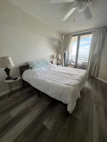 a large bed sitting in a bedroom next to a window