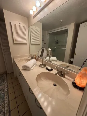 a bathroom with a double vanity sink and a mirror