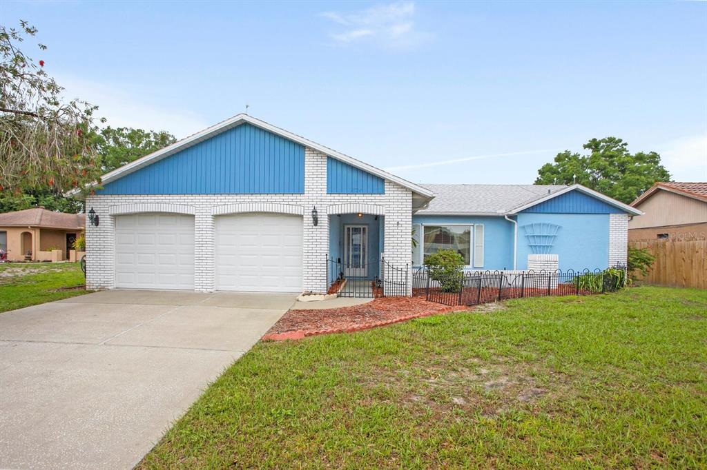 7024 Mistletoe Court New Port Richey, FL 34653 - Photo 1 of 1 a front view of house with a garden and patio
