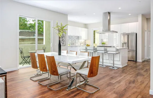 a view of a kitchen with kitchen island dining table and a large window