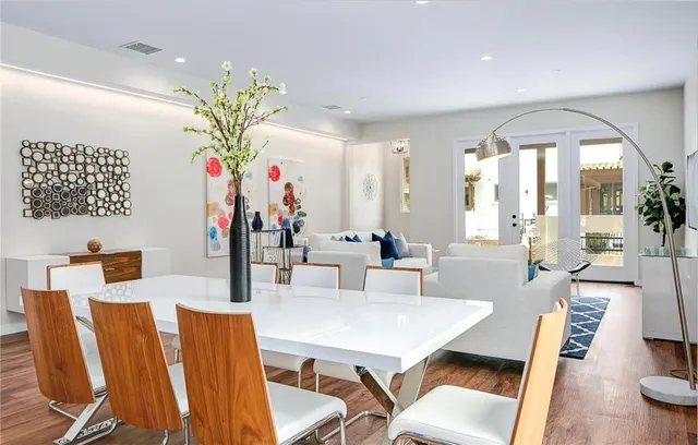 a view of a dining room with furniture and a chandelier