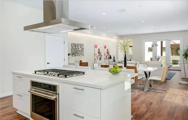 a kitchen that has a stove and a table