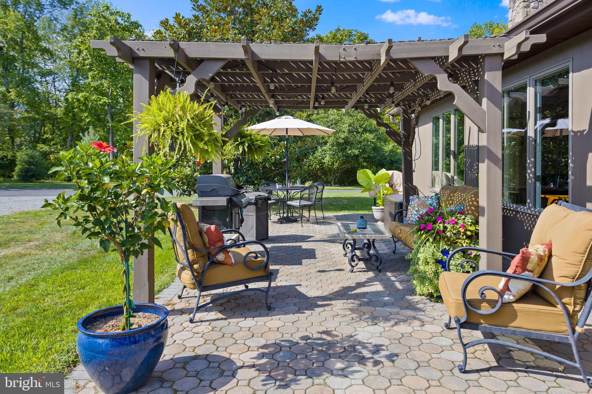 409 Federal City Road Pennington, NJ 08534 - Photo 11 of 54 a view of a patio with table and chairs potted plants