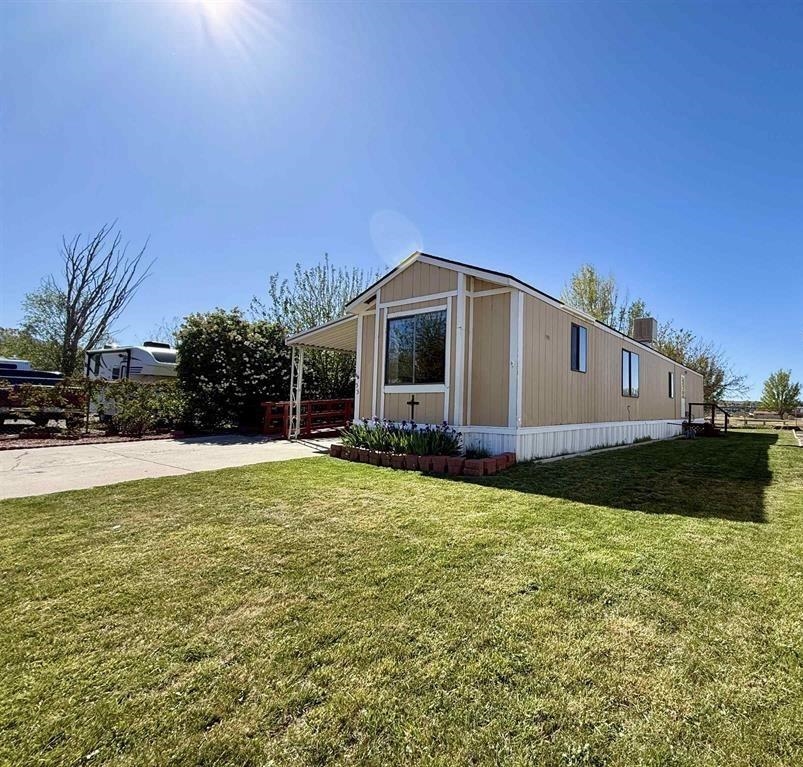 3251 E Road, Unit 33 Clifton, CO 81520 - Photo 1 of 28 a front view of house with yard and garage