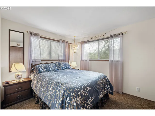 a bedroom with a large bed and window