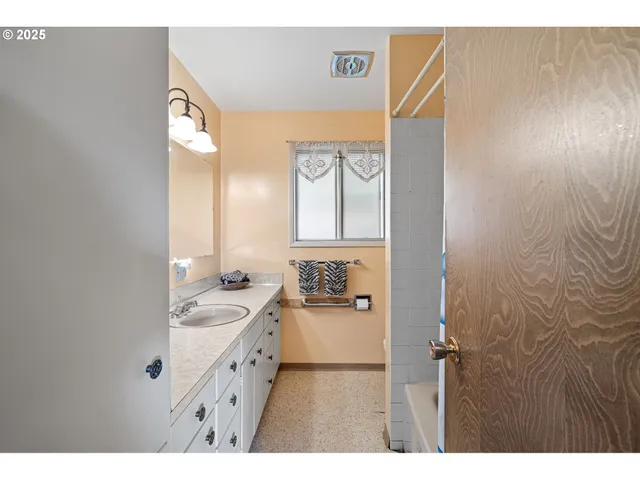 a bathroom with a double vanity sink a mirror and a shower