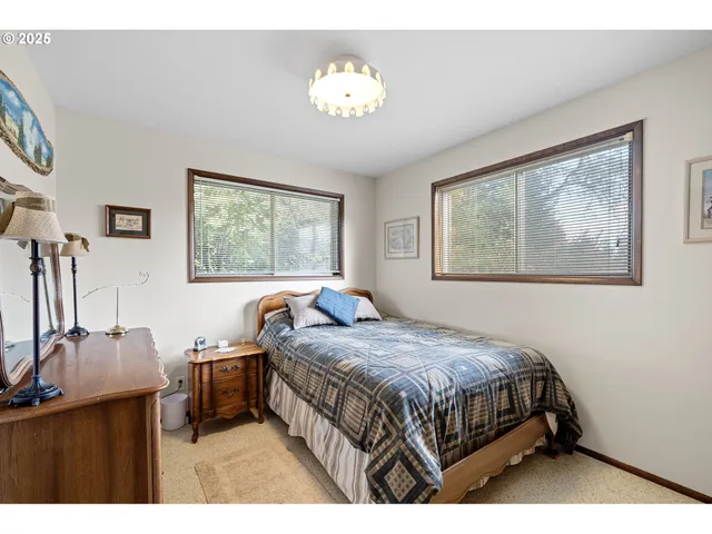 a bedroom with a bed next to a window