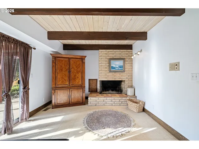 a view of living room with furniture and a fireplace