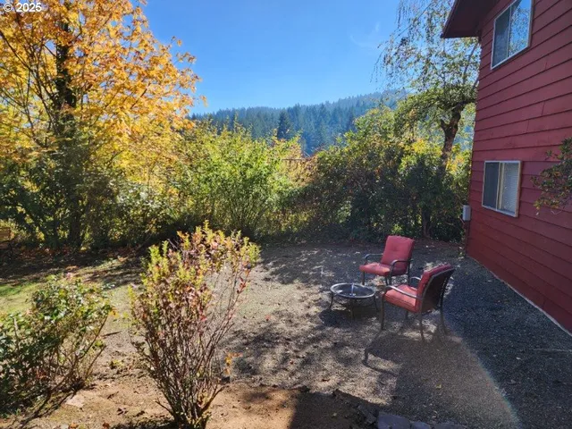 a view of a backyard with sitting area