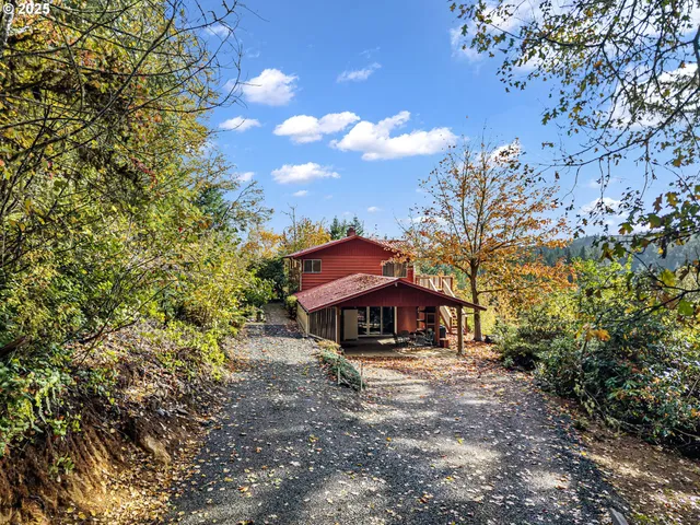 a view of house with outdoor space and trees