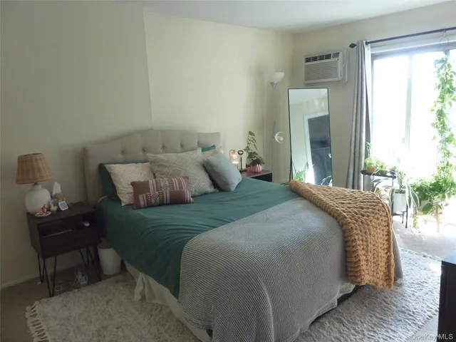 a bedroom with bed and window