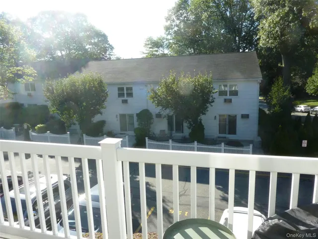 a view of a white house with a yard