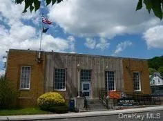 a view of a brick house with many windows