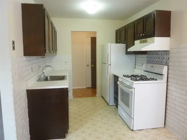 a kitchen with a sink and a stove top oven