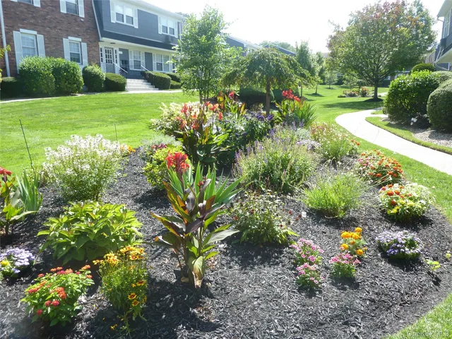 a view of a garden with a building