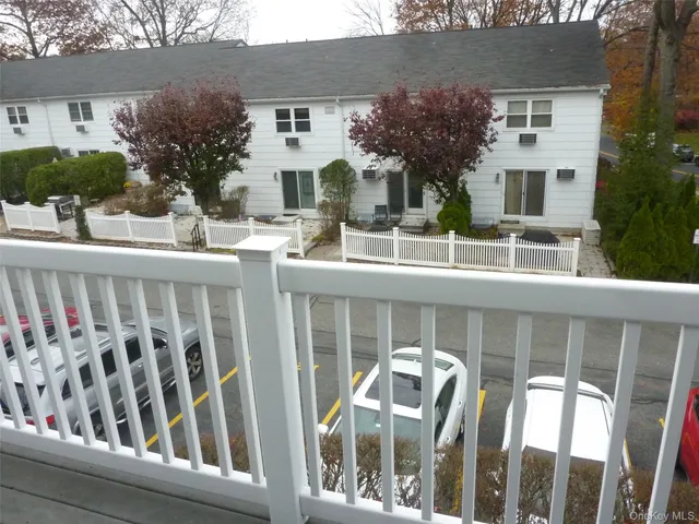 a view of a house with wooden deck and furniture