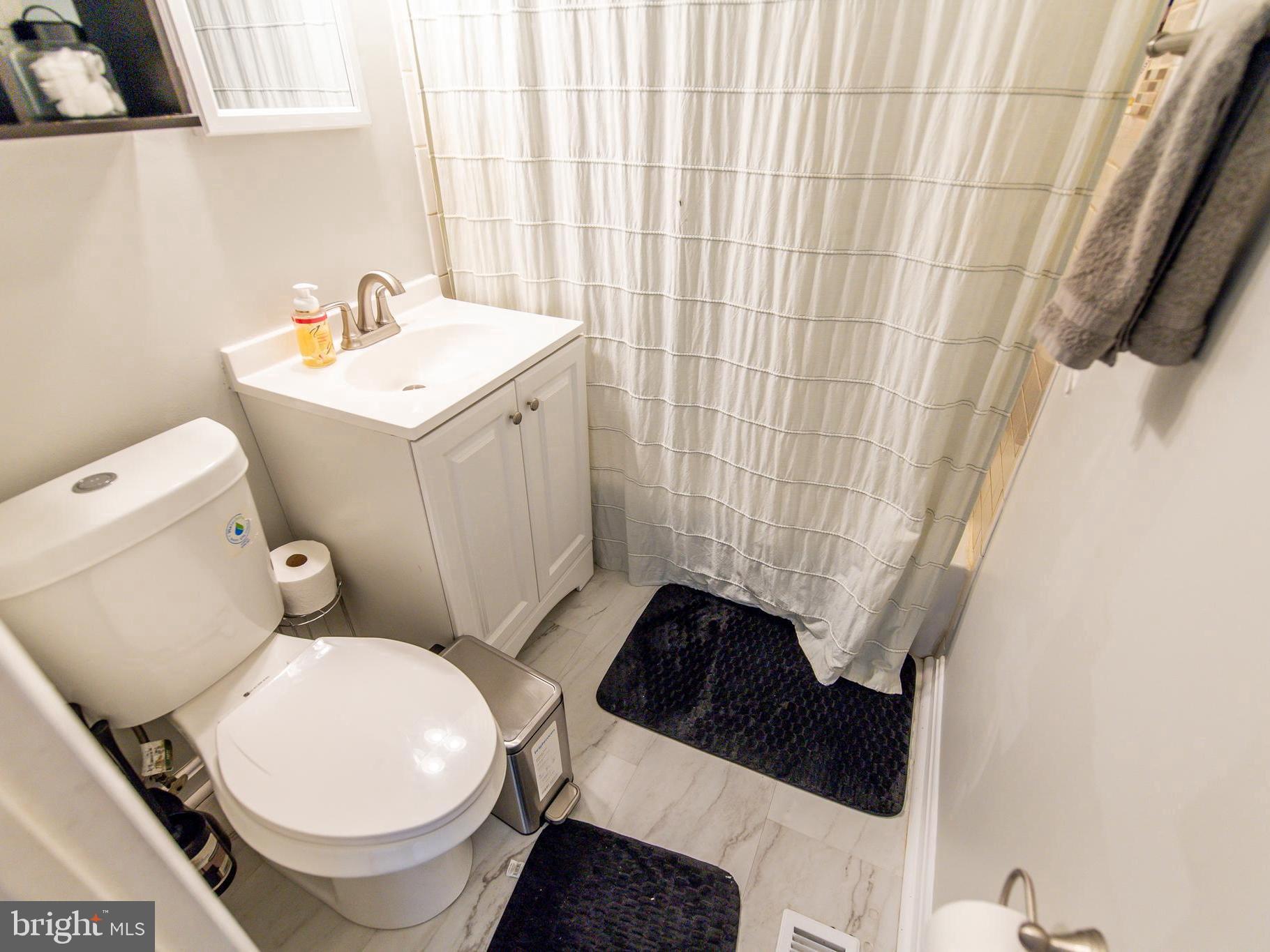 8222 Cornwall Road Dundalk, MD 21222 - Photo 12 of 31 a white toilet sitting next to a bathroom sink