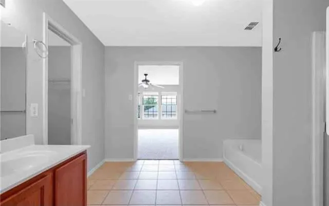 a bathroom with a granite countertop sink a toilet and bathtub