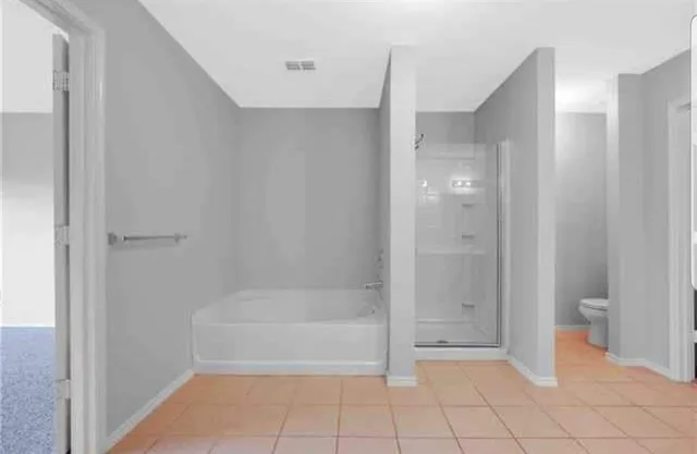 a bathroom with a bath tub and glass door
