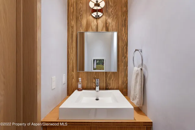 a bathroom with a sink a mirror and vanity