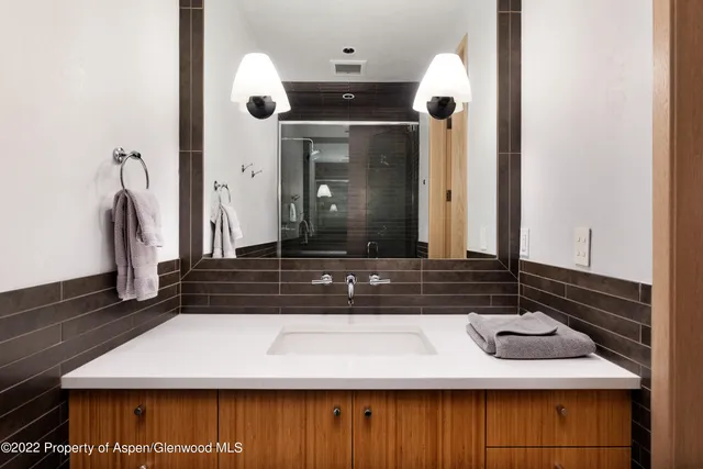 a bathroom with a sink a mirror and vanity