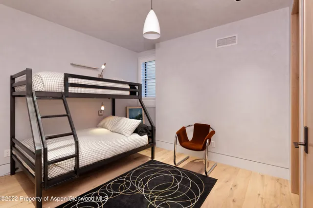 a bedroom with a bed and a chandelier