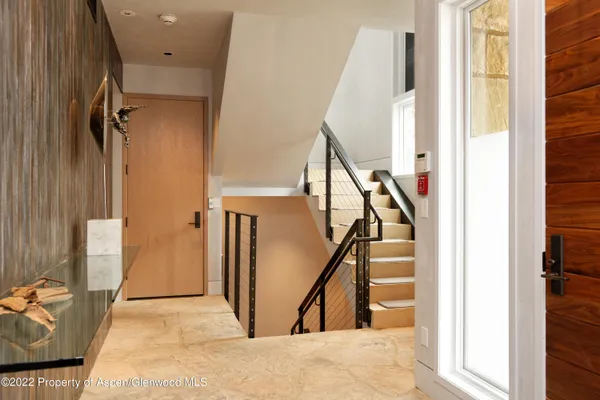 a view of a livingroom with stairs and a couch