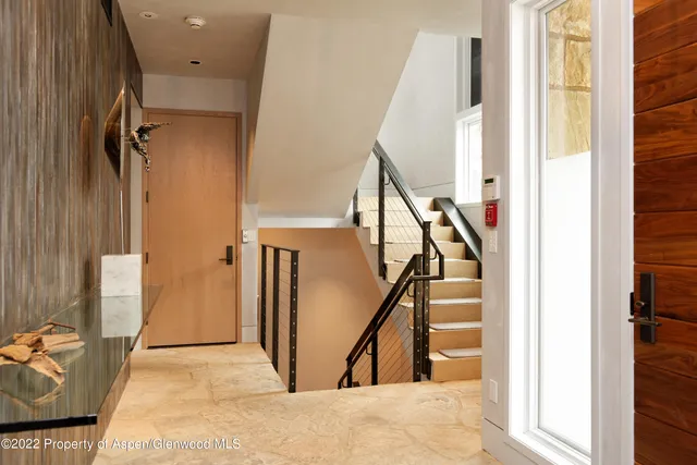 a view of a livingroom with stairs and a couch