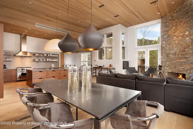 a kitchen with a table chairs and a stove