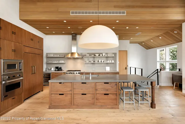 a kitchen with cabinets and wooden floor