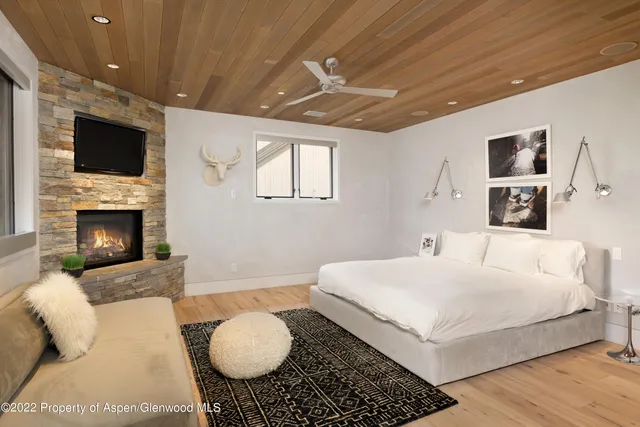 a bedroom with a large bed and a flat screen tv