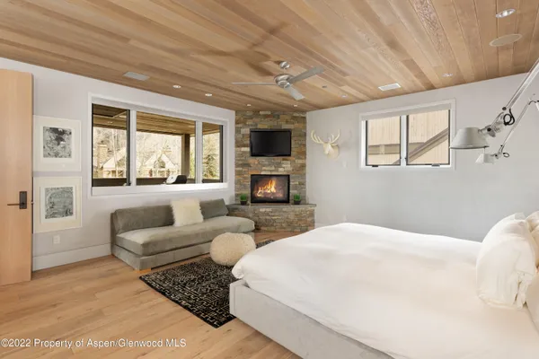 a bedroom with furniture and a flat screen tv